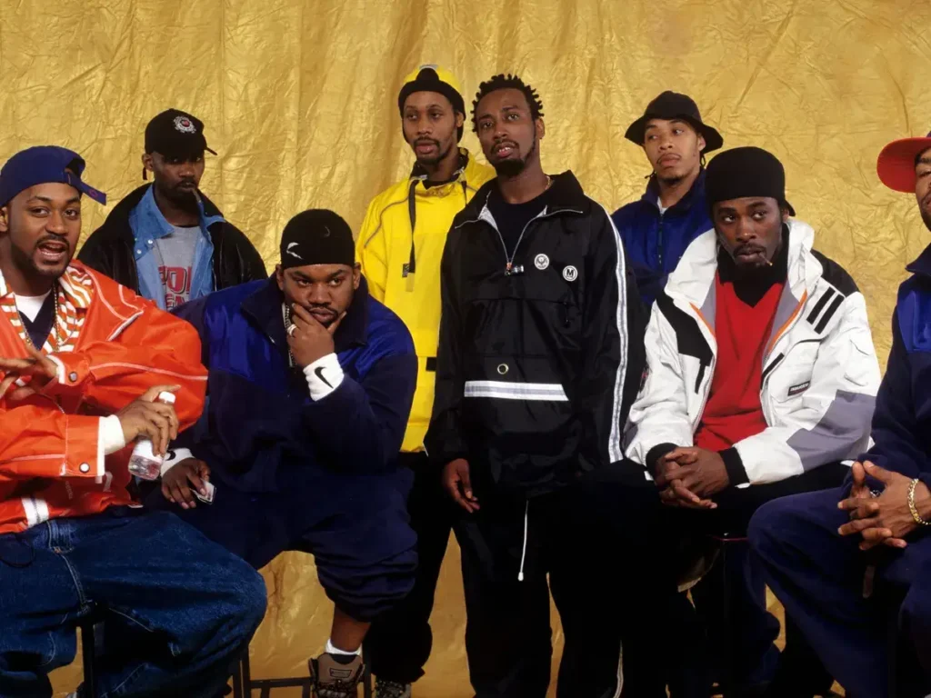 9 members of wu tang clan facing a photograph after successful song release